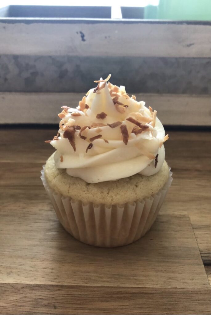 Vanilla cupcake with vanilla buttercream and toasted coconut.